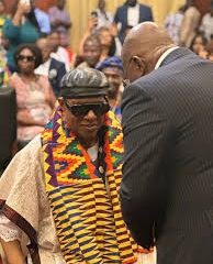 President Nana Addo handing citizen form to Stevie Wonder